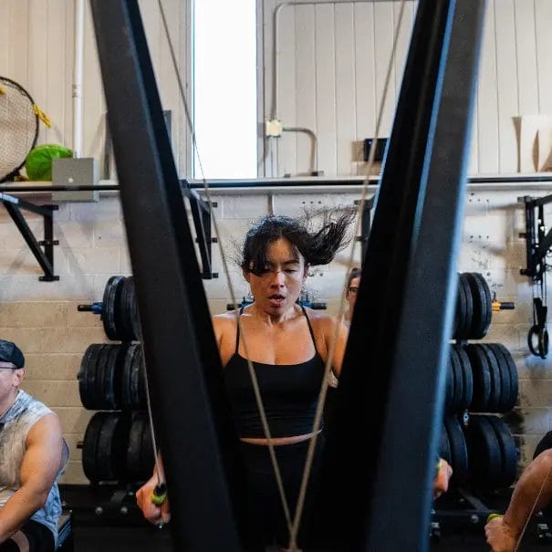 Woman working out on pull out machine